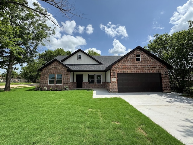 500 Ennis Scott St, Ferris, TX 75125 - view of front of property featuring a garage, a front yard, brick siding, driveway, and a shingled roof
