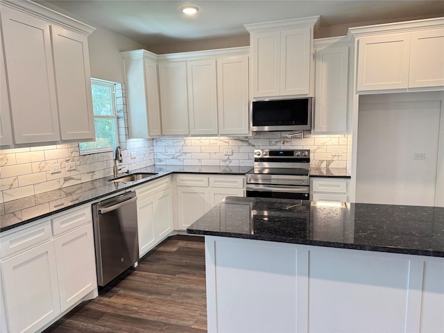 500 Ennis Scott St, Ferris, TX 75125 - kitchen with appliances with stainless steel finishes, white cabinetry, dark wood-type flooring, dark stone countertops, and recessed lighting