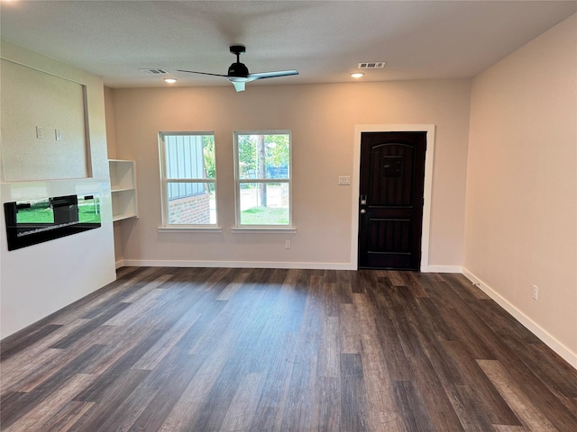 500 Ennis Scott St, Ferris, TX 75125 - unfurnished living room with ceiling fan, dark wood-style flooring, and recessed lighting