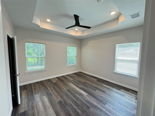 500 Ennis Scott St, Ferris, TX 75125 - unfurnished room featuring a tray ceiling, ceiling fan, dark wood-style floors, and recessed lighting