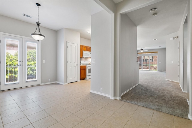 626 Oakland Hills Ln, Frisco, TX 75036 - unfurnished room featuring light tile patterned floors, french doors, a ceiling fan, light colored carpet, and a smoke detector
