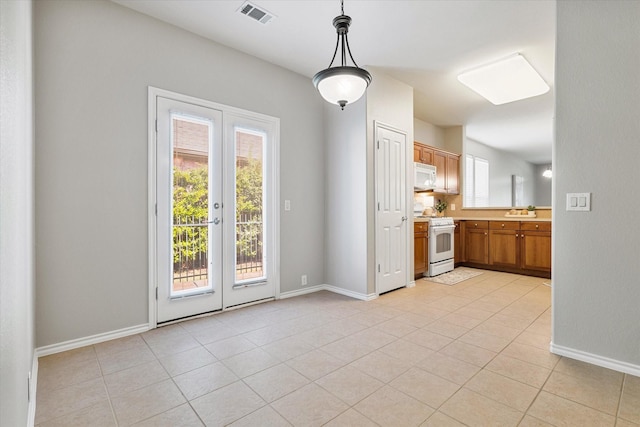 626 Oakland Hills Ln, Frisco, TX 75036 - kitchen with white appliances, plenty of natural light, light countertops, and decorative light fixtures