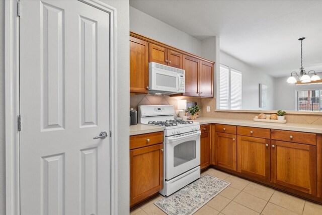 626 Oakland Hills Ln, Frisco, TX 75036 - kitchen with white appliances, healthy amount of natural light, and brown cabinets