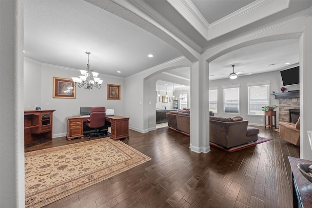 2209 Therese Dr, Waco, TX 76712 - home office featuring dark wood-type flooring, a fireplace, a ceiling fan, arched walkways, and a chandelier