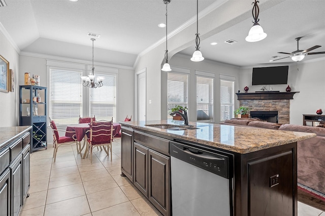 2209 Therese Dr, Waco, TX 76712 - kitchen featuring stainless steel dishwasher, crown molding, a stone fireplace, ceiling fan, and light tile patterned floors