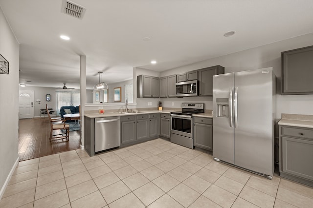 4505 Martingale View Ln, Fort Worth, TX 76244 - kitchen featuring stainless steel appliances, gray cabinetry, light countertops, recessed lighting, and ceiling fan