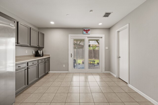 4505 Martingale View Ln, Fort Worth, TX 76244 - kitchen with gray cabinets, stainless steel fridge, light countertops, and recessed lighting