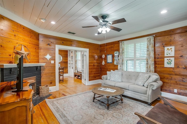 501 W Parks Ave, Waxahachie, TX 75165 - living room with crown molding, ceiling fan, wood walls, light wood-style flooring, and recessed lighting