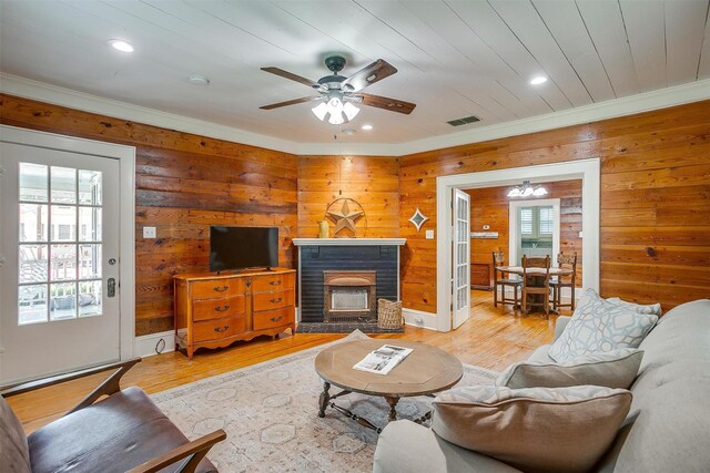 501 W Parks Ave, Waxahachie, TX 75165 - living area with light wood finished floors, wooden walls, recessed lighting, ornamental molding, and a ceiling fan