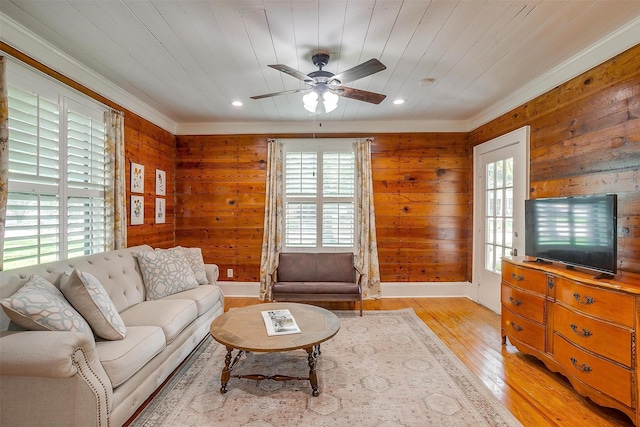 501 W Parks Ave, Waxahachie, TX 75165 - living room with healthy amount of natural light, a ceiling fan, wood walls, light wood-style floors, and ornamental molding