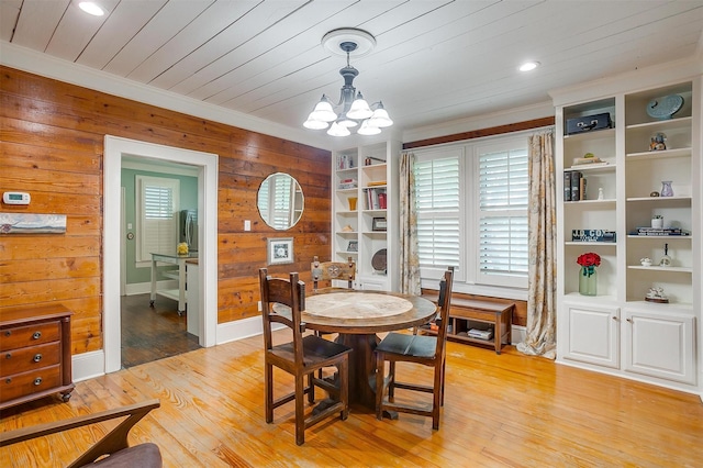 501 W Parks Ave, Waxahachie, TX 75165 - dining space with a chandelier, wooden walls, crown molding, light wood-type flooring, and recessed lighting