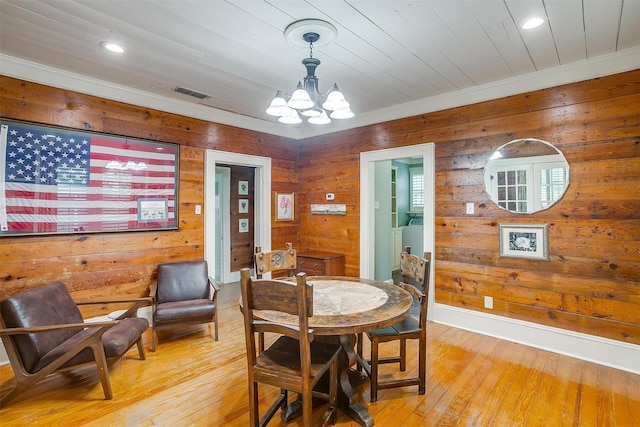 501 W Parks Ave, Waxahachie, TX 75165 - dining area with a chandelier, wooden walls, light wood-style floors, recessed lighting, and crown molding