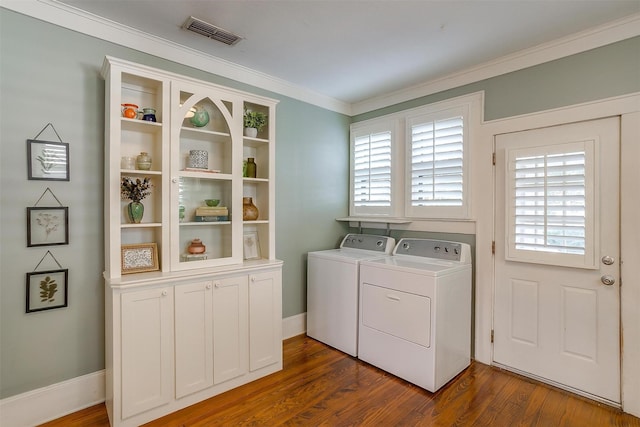 501 W Parks Ave, Waxahachie, TX 75165 - laundry area featuring cabinet space, washer and dryer, ornamental molding, dark wood-style floors, and plenty of natural light