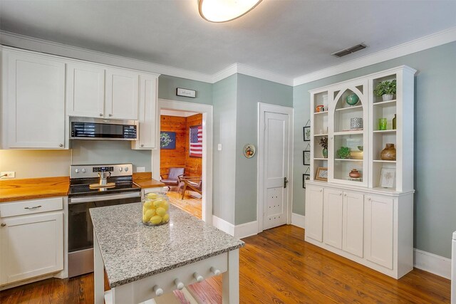 501 W Parks Ave, Waxahachie, TX 75165 - kitchen featuring appliances with stainless steel finishes, white cabinetry, open shelves, butcher block countertops, and ornamental molding
