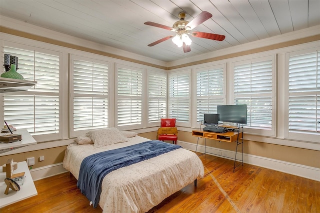 501 W Parks Ave, Waxahachie, TX 75165 - bedroom with multiple windows, wood finished floors, crown molding, wood ceiling, and a ceiling fan