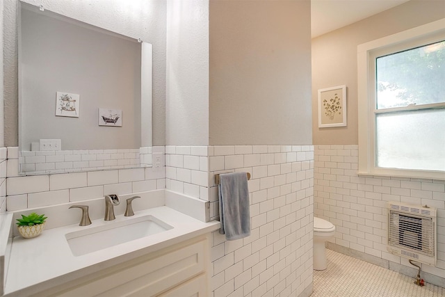 501 W Parks Ave, Waxahachie, TX 75165 - half bathroom featuring heating unit, tile walls, and vanity