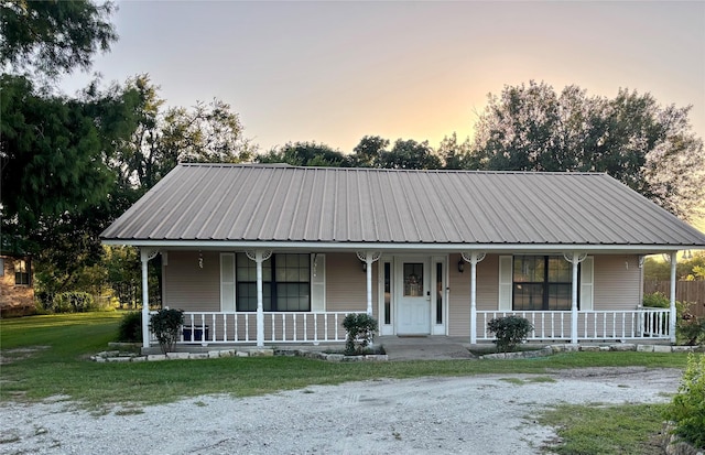 1006 S State Highway 14, Thornton, TX 76687 - farmhouse-style home featuring a porch, a metal roof, and a front yard