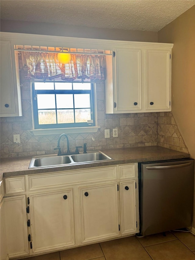 1006 S State Highway 14, Thornton, TX 76687 - kitchen with dishwasher, light tile patterned flooring, decorative backsplash, white cabinets, and a textured ceiling