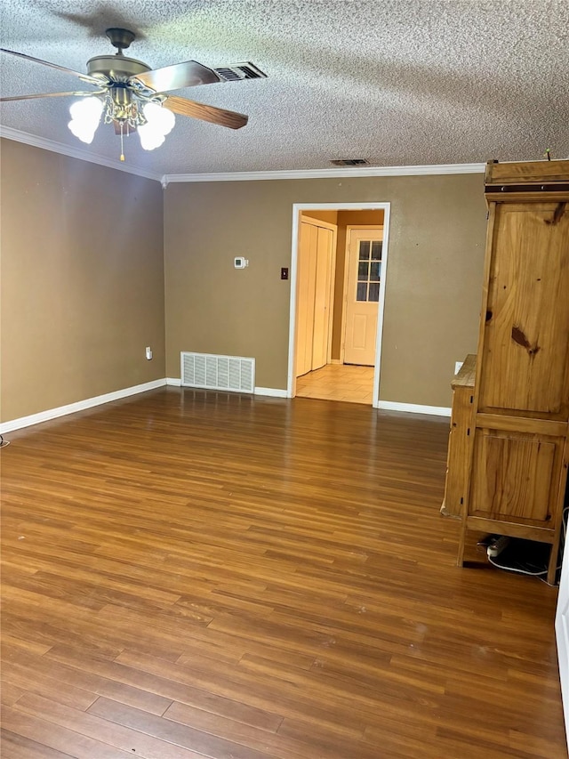 1006 S State Highway 14, Thornton, TX 76687 - unfurnished room featuring crown molding, wood finished floors, ceiling fan, and a textured ceiling