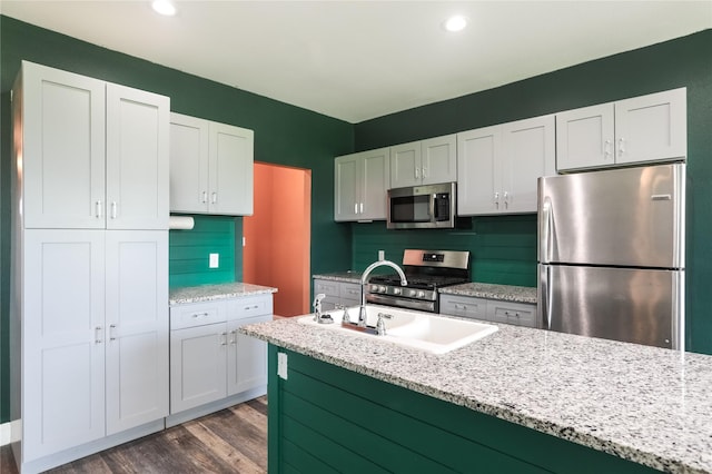 392 Calle Cedro Dr, Sherman, TX 75090 - kitchen featuring stainless steel appliances, white cabinets, dark wood finished floors, light stone counters, and recessed lighting