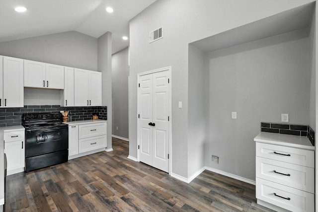 6604 Kingsferry Ct, Arlington, TX 76016 - kitchen featuring black range with electric cooktop, light countertops, white cabinetry, backsplash, and vaulted ceiling