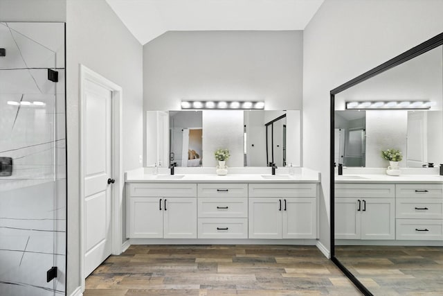 6604 Kingsferry Ct, Arlington, TX 76016 - full bath with double vanity, a stall shower, wood finished floors, and vaulted ceiling