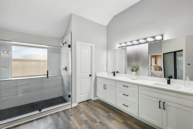 6604 Kingsferry Ct, Arlington, TX 76016 - full bathroom featuring lofted ceiling, double vanity, a stall shower, and wood finished floors