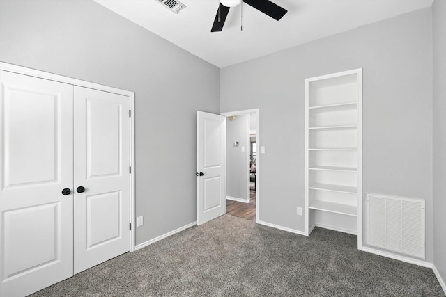 6604 Kingsferry Ct, Arlington, TX 76016 - unfurnished bedroom featuring dark carpet, a closet, and a ceiling fan