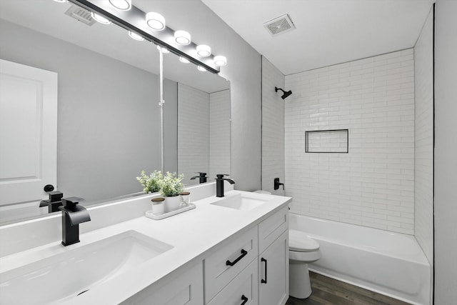 6604 Kingsferry Ct, Arlington, TX 76016 - bathroom with double vanity, wood finished floors, and shower / bath combination