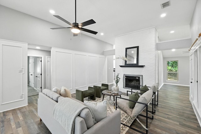 6604 Kingsferry Ct, Arlington, TX 76016 - living room with wood finished floors, a large fireplace, ceiling fan, a decorative wall, and recessed lighting
