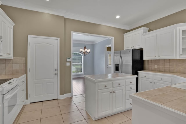 245 Harders Crossing Blvd, Shreveport, LA 71106 - kitchen with tile counters, white appliances, a chandelier, white cabinetry, and ornamental molding