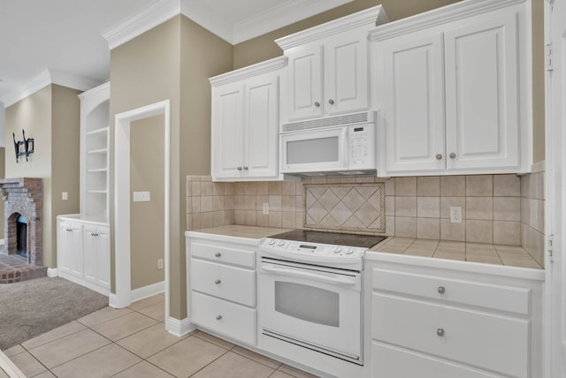 245 Harders Crossing Blvd, Shreveport, LA 71106 - kitchen with white appliances, tile countertops, white cabinets, ornamental molding, and decorative backsplash