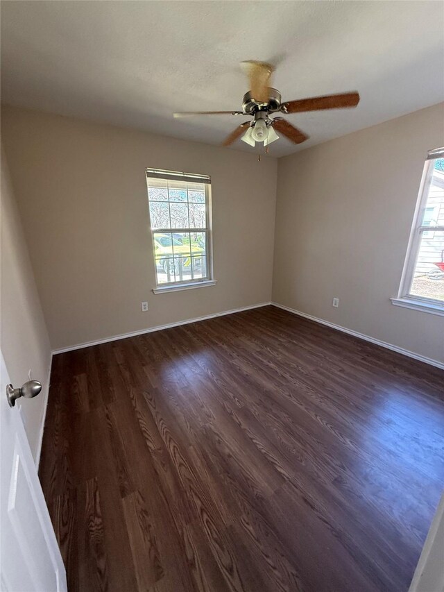 900 Reese Ln, Azle, TX 76020 - unfurnished room with healthy amount of natural light, dark wood-style flooring, and a ceiling fan