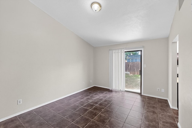 2411 Brookdale Dr, Arlington, TX 76014 - spare room featuring dark tile patterned floors and baseboards
