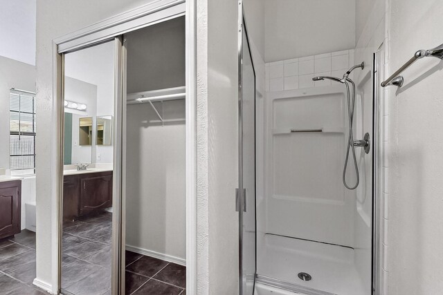 2411 Brookdale Dr, Arlington, TX 76014 - full bath featuring a stall shower, vanity, tile patterned floors, and a closet