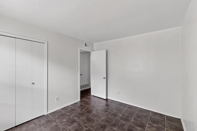 2411 Brookdale Dr, Arlington, TX 76014 - unfurnished bedroom featuring a closet and baseboards