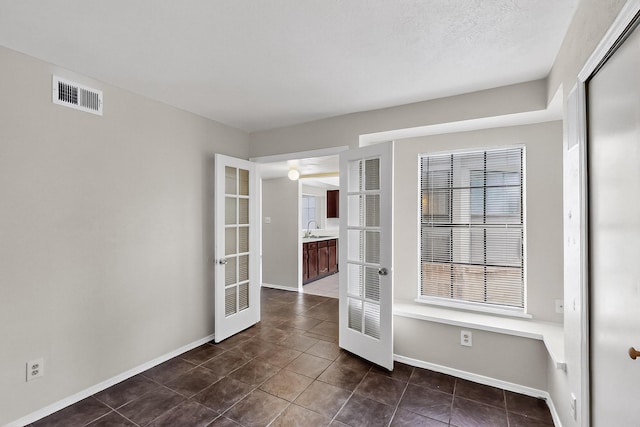 2411 Brookdale Dr, Arlington, TX 76014 - unfurnished room with dark tile patterned floors