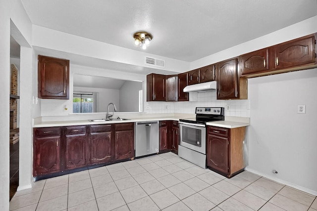 2411 Brookdale Dr, Arlington, TX 76014 - kitchen featuring appliances with stainless steel finishes, under cabinet range hood, light countertops, decorative backsplash, and light tile patterned floors