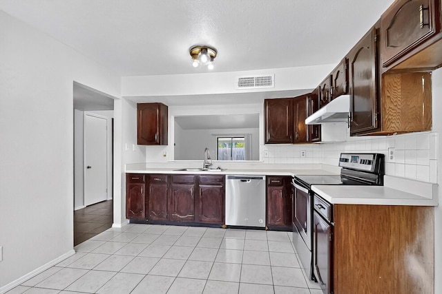 2411 Brookdale Dr, Arlington, TX 76014 - kitchen featuring appliances with stainless steel finishes, under cabinet range hood, light countertops, light tile patterned flooring, and dark brown cabinets