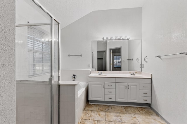 201 Settlers Glen Trl, Arlington, TX 76002 - bathroom featuring lofted ceiling, double vanity, a stall shower, a garden tub, and stone finish flooring