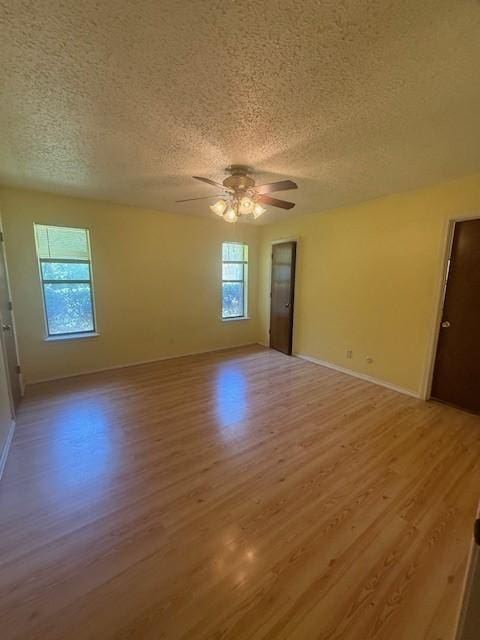 8761 S County Rd, Frisco, TX 75034 - unfurnished room featuring a textured ceiling, light wood finished floors, and ceiling fan