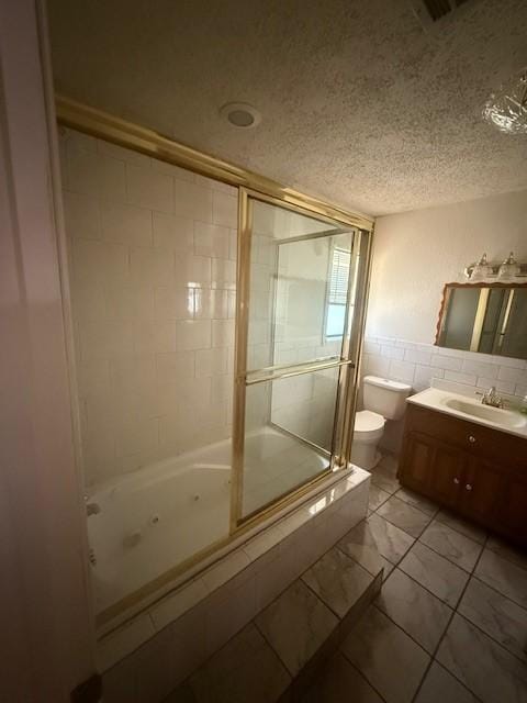 8761 S County Rd, Frisco, TX 75034 - bathroom featuring a combined bath / shower with jetted tub, tile walls, vanity, and a textured ceiling