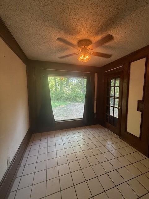 8761 S County Rd, Frisco, TX 75034 - spare room featuring a textured ceiling, a ceiling fan, and light tile patterned flooring
