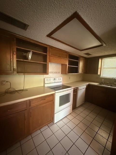 8761 S County Rd, Frisco, TX 75034 - kitchen with white appliances, open shelves, a textured ceiling, light tile patterned flooring, and light countertops