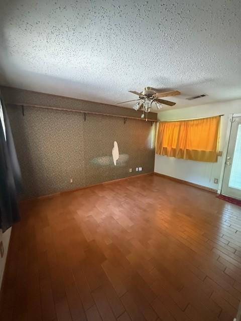 8761 S County Rd, Frisco, TX 75034 - empty room with ceiling fan, wood finished floors, and a textured ceiling