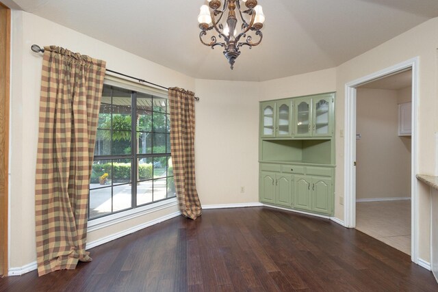 6515 Genstar Ln, Dallas, TX 75252 - unfurnished dining area with a chandelier and dark wood-type flooring