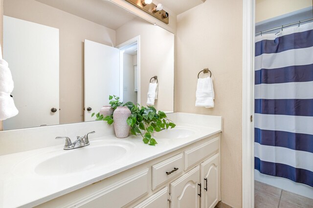 6515 Genstar Ln, Dallas, TX 75252 - full bath featuring double vanity, tile patterned floors, and curtained shower