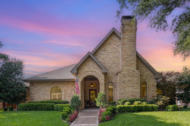 6515 Genstar Ln, Dallas, TX 75252 - english style home with a lawn, a chimney, and brick siding