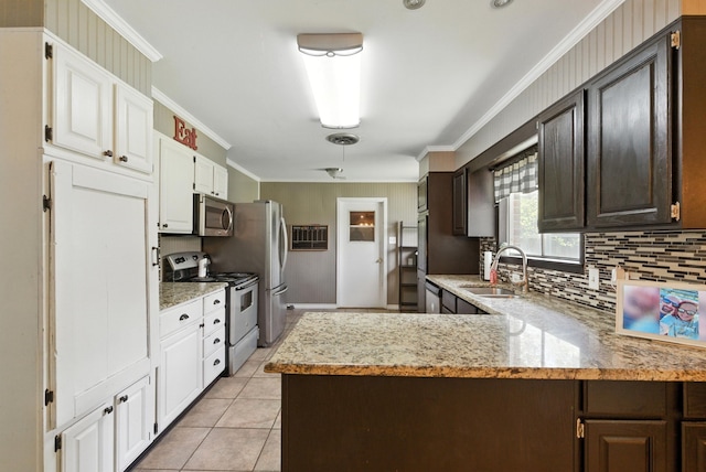 1442 W Water St, Weatherford, TX 76086 - kitchen with stainless steel appliances, ornamental molding, decorative backsplash, white cabinets, and light stone counters
