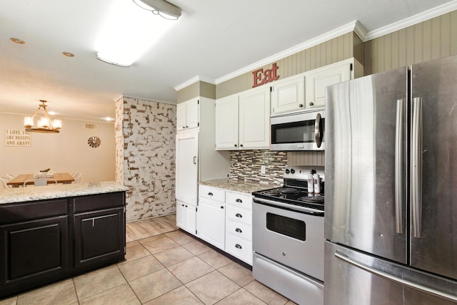 1442 W Water St, Weatherford, TX 76086 - kitchen with stainless steel appliances, crown molding, white cabinets, light stone countertops, and a chandelier